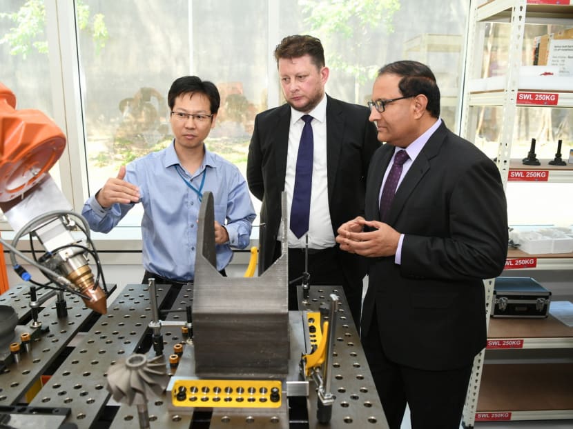 Mr S Iswaran (right), Minister of Trade and Industry (Industry), with Mr Matthew Waterhouse (centre), CEO of 3D Metalforge, at the company’s 3D metal printing facility dedicated to commercial use. PHOTO: 3D METALFORGE