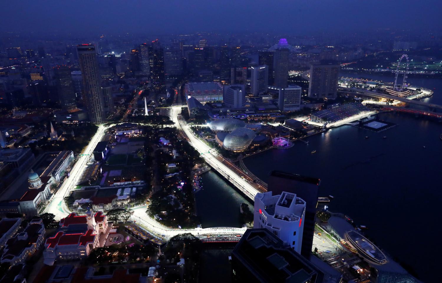 An aerial view of the Marina Bay area in September 2019, with several hotels in the background overlooking the lighted street circuit for the Formula One night race in Singapore. An aerial view of the Marina Bay area in September 2019, with several hotels in the background overlooking the lighted street circuit for the Formula One night race in Singapore.