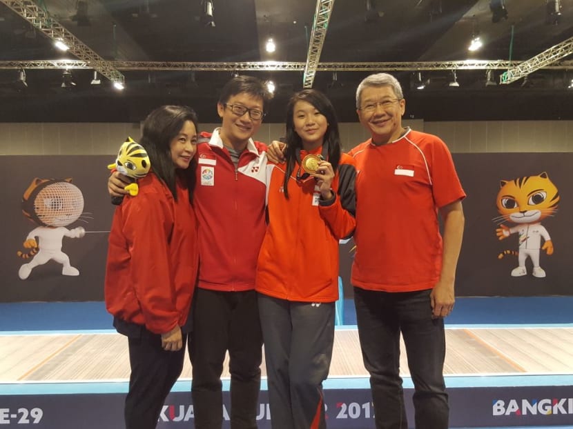 Lau Ywen with her parents and coach David Chan celebrating her win. Photo: Teo Teng Kiat/TODAY