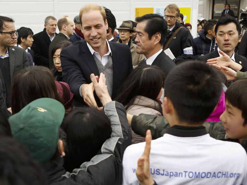 Britain's Prince William, Duke of Cambridge, shakes hands with members of the public during a visit of the Chime of Hope Shopping Centre in Onagawa on  March 1, 2015.  Prince William is in Japan for a four-day visit. The city of Onagawa in northern Japan was severely damaged during the March 2011 earthquake and tsunami. Photo: Reuters