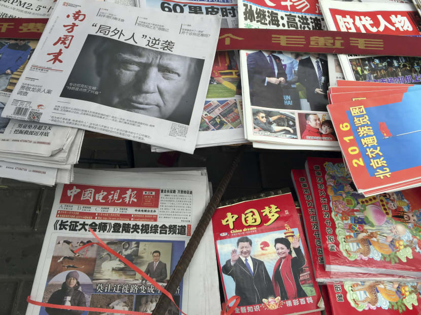 A front page of a Chinese newspaper with a photo of U.S. President-elect Donald Trump and the headline "Outsider counter attack" is displayed at a newsstand in Beijing, China, Thursday, Nov. 10, 2016. AP file photo