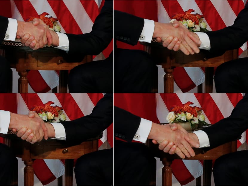 A combination photo shows US President Donald Trump (L) trying twice to let go of a handshake with France's President Emmanuel Macron (R) as Macron holds tight, before a working lunch ahead of a NATO Summit in Brussels, Belgium. Photo: Reuters