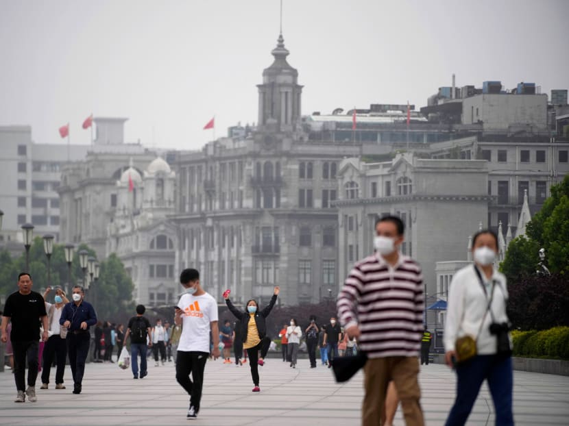 People wearing face masks visit the Bund, after the lockdown placed to curb the Covid-19 outbreak was lifted in Shanghai on June 1, 2022. 