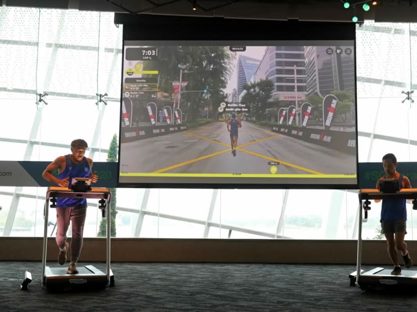 On the screen (centre), the avatars of Mr Lim Teck Yin (left), chief executive officer of Sport Singapore, and Mr Keith Tan (right), CEO of Singapore Tourism Board, run through Orchard Road. This is the augmented reality race that will be part of the Standard Chartered Singapore Marathon 2020.