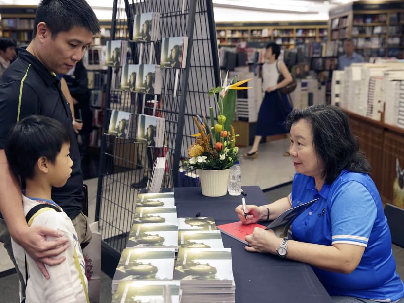 Joseph Schooling's mother, May Schooling signing an autograph on the first book about her son, titled ''Hello, my name is Joseph Schooling'', for those who buy them at Kinokuniya Bookstore on Oct 7, 2016. Photo: Wee Teck Hian/TODAY