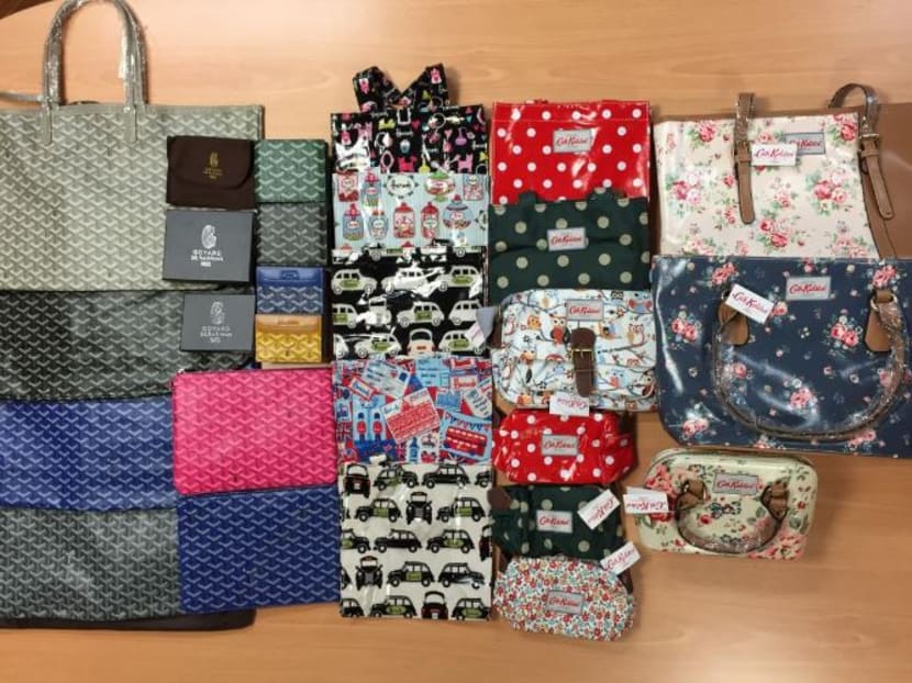 Some of the 700 counterfeit women’s bags and wallets detained by Singapore Customs today (May 6). Photo: Singapore Customs