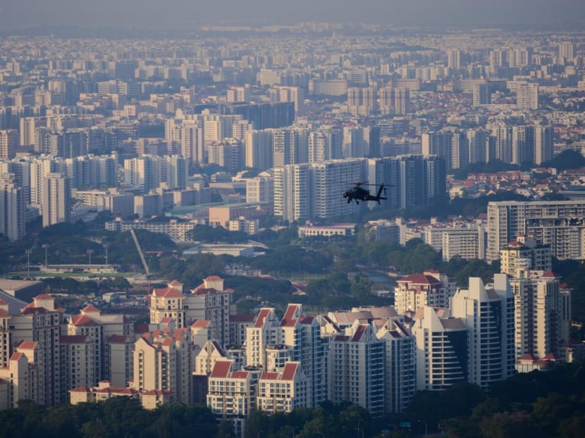 A Singapore Air Force Apache attack helicopter flying over buildings in eastern Singapore.