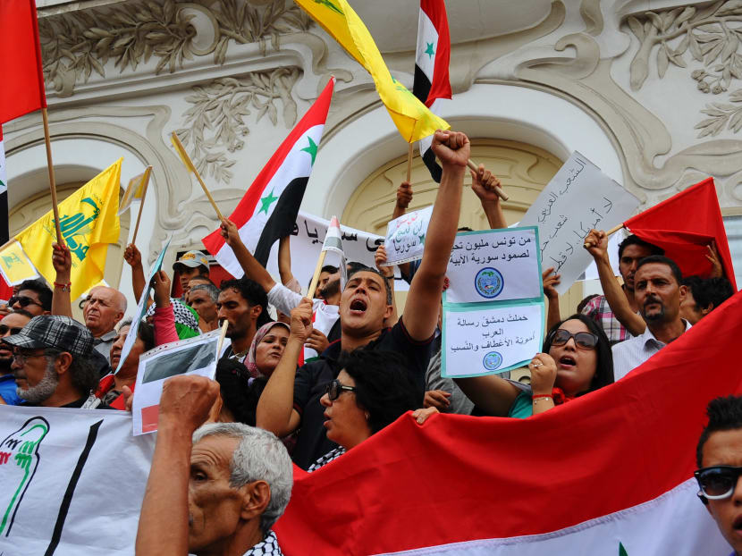 Syrian demonstrators shout during a rally. (AP/Hassene Dridi)
