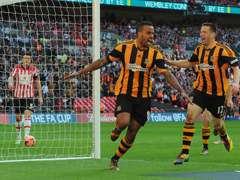 Hull City's Tom Huddlestone, centre,  celebrates after scoring against Sheffield United during their English FA Cup semifinal football match between Hull City and Sheffield United at Wembley Stadium, in London, Sunday, April 13, 2014. Photo: AP