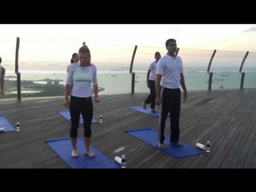 Simona Halep does yoga at the Marina Bay Sands sky park