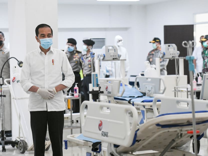 Indonesia's President Joko Widodo takes a look at the emergency hospital handling of Covid-19 in Kemayoran Athletes Village in Jakarta on March 23.