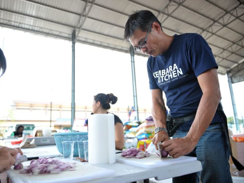 Founder of Kembara Kitchen, William Cheah, (right) helping with the food preparation. Photo: The Malay Mail Online