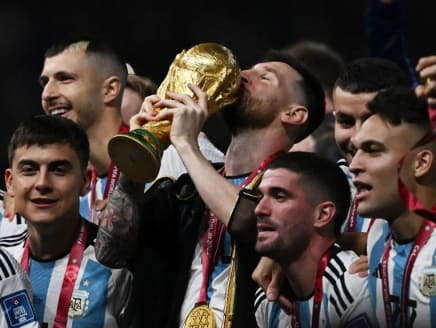 Argentina’s Lionel Messi kissed the World Cup trophy as he and his teammates celebrated their victory against France on Sunday in the final.