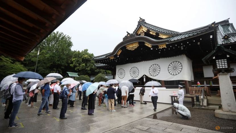Japan's Suga pledges not to wage war again as ministers visit controversial shrine