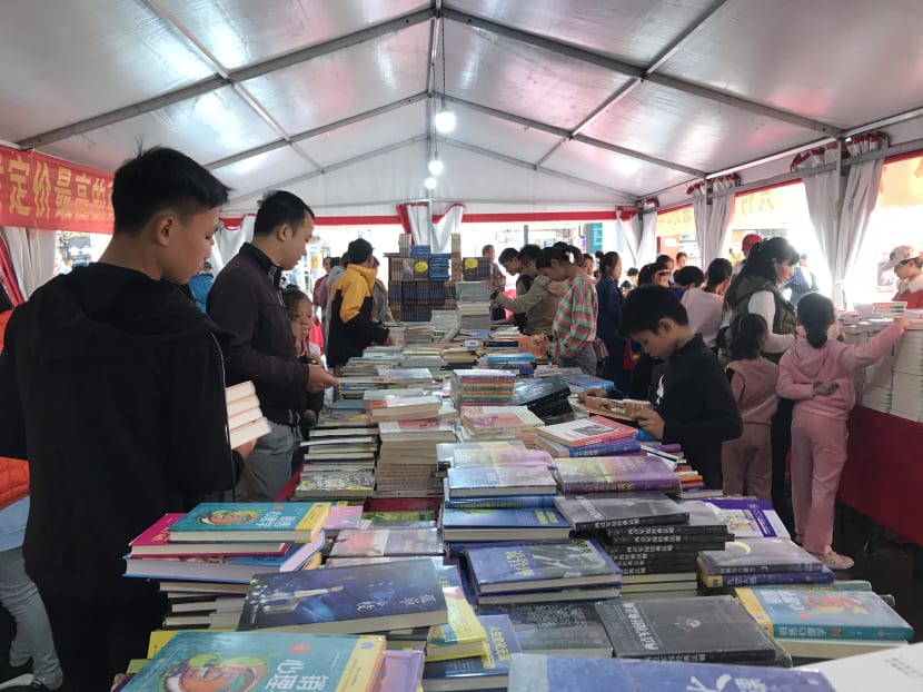 Shoppers browsing books on sale at a store in Hainan, China, in this photo taken by the author on Dec 8, 2019. Her experience studying there got her thinking about accessibility of books in her home country of Indonesia.