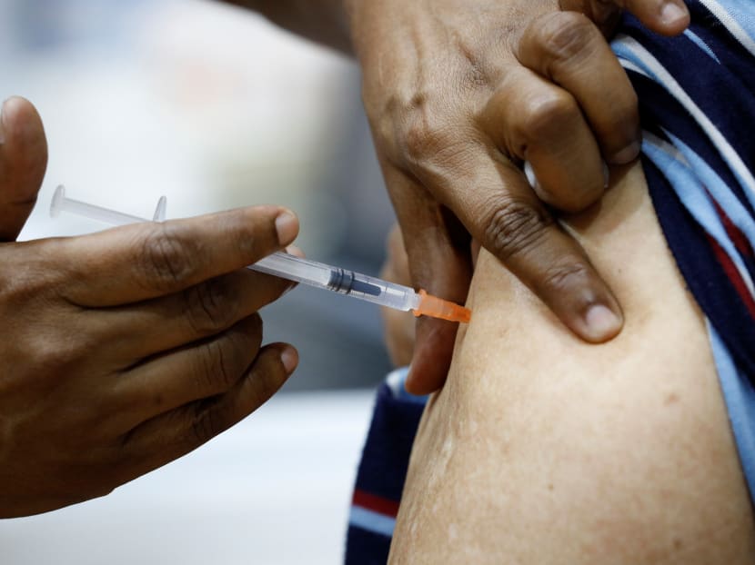 A man receives his vaccination at a Covid-19 vaccination centre in Singapore on March 8, 2021.