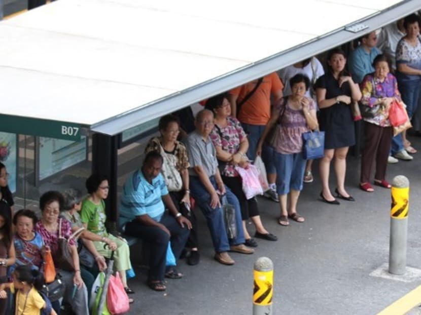People waiting at a bus stop. Photo: Channel NewsAsia