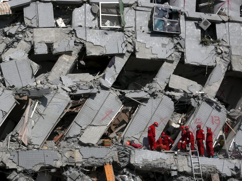 Rescue personnel work at the site where a 17-storey apartment building collapsed after an earthquake hit Tainan, southern Taiwan. Photo: Reuters