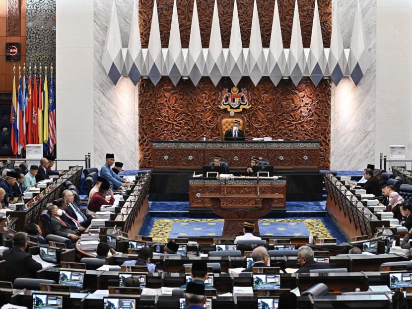 Finance Minister Tengku Zafrul Tengku Abdul Aziz (L) delivers a speech as he unveils the national 2023 budget at the Parliament in Kuala Lumpur.