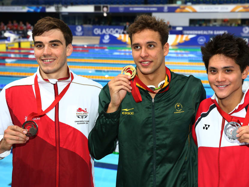 Gold medallist Chad le Clos of South Africa poses with silver medallist Joseph Schooling (right) of Singapore and bronze medallist Adam Barrett of England after the medal ceremony for the Men's 100m Butterfly Final at Tollcross International Swimming Centre during day five of the Glasgow 2014 Commonwealth Games on July 28, 2014 in Glasgow, Scotland. Photo: Getty Images