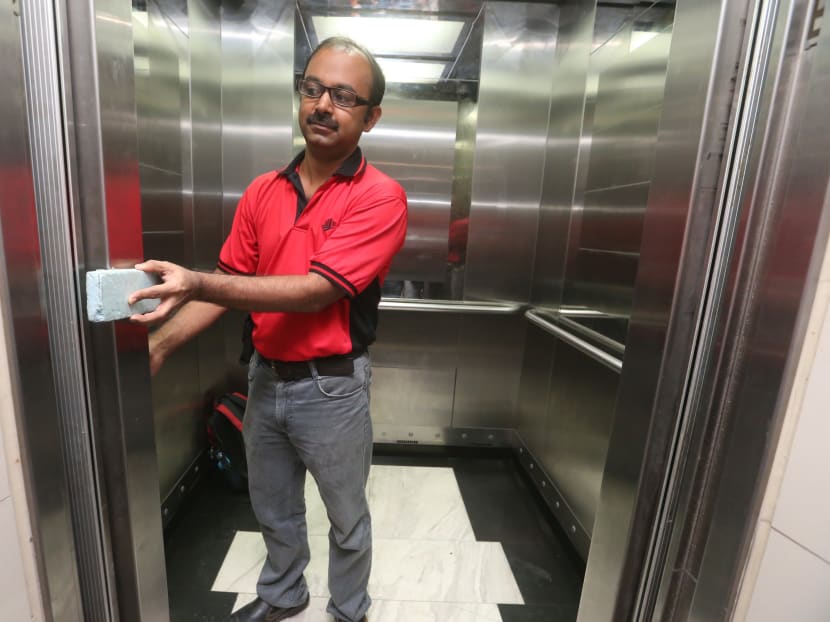 A BCA engineer checking the sensors in a lift. TODAY file photo
