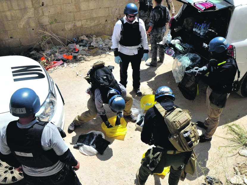 UN chemical weapons experts prepare before collecting samples from one of the sites of the alleged chemical weapons attack in Damascus late last month. Photo: Reuters
