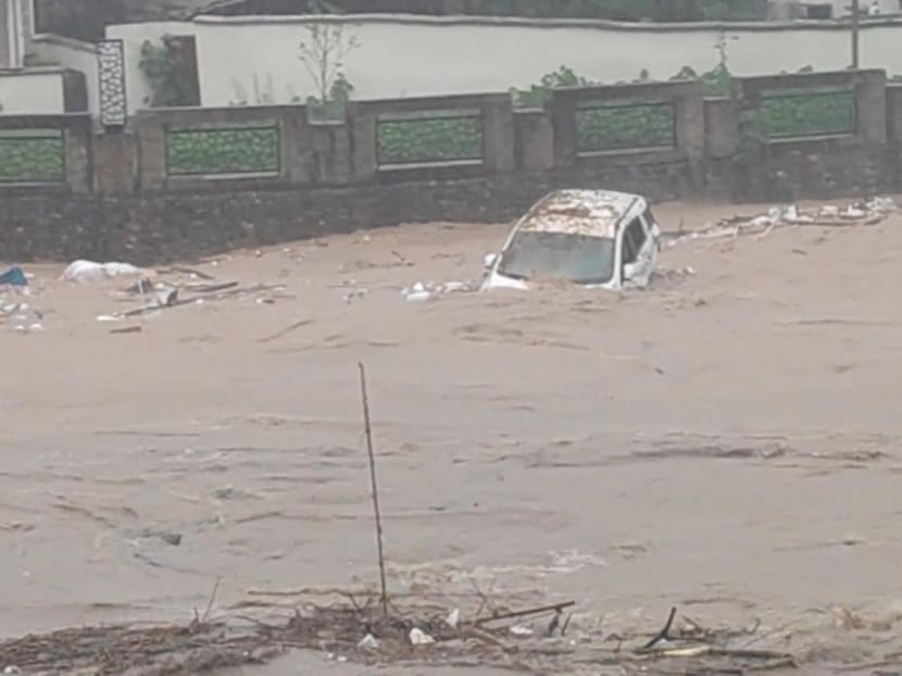 A vehicle is swept by the floodwaters following heavy rainfall in Jiangwan, Guangdong, China in this screengrab taken from a social media video released on April 22, 2024.