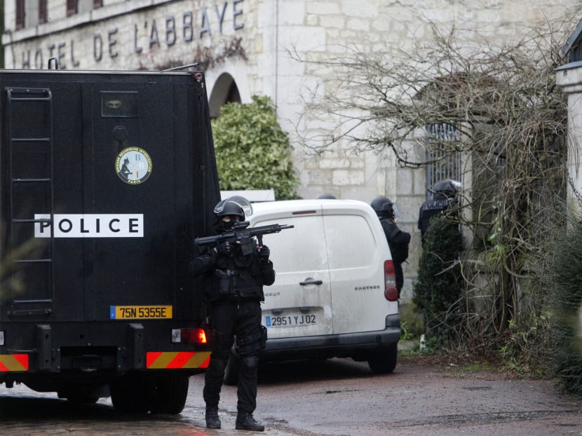 Armed police officers patrol in the village of Longpont, northeast of Paris, hunting  the two heavily armed brothers suspected in the massacre at Charlie Hebdo newspaper, Thursday, Jan. 8, 2015. Scattered gunfire and explosions shook France on Thursday as its frightened yet defiant citizens held a day of mourning for 12 people slain at a Paris newspaper. Photo: AP