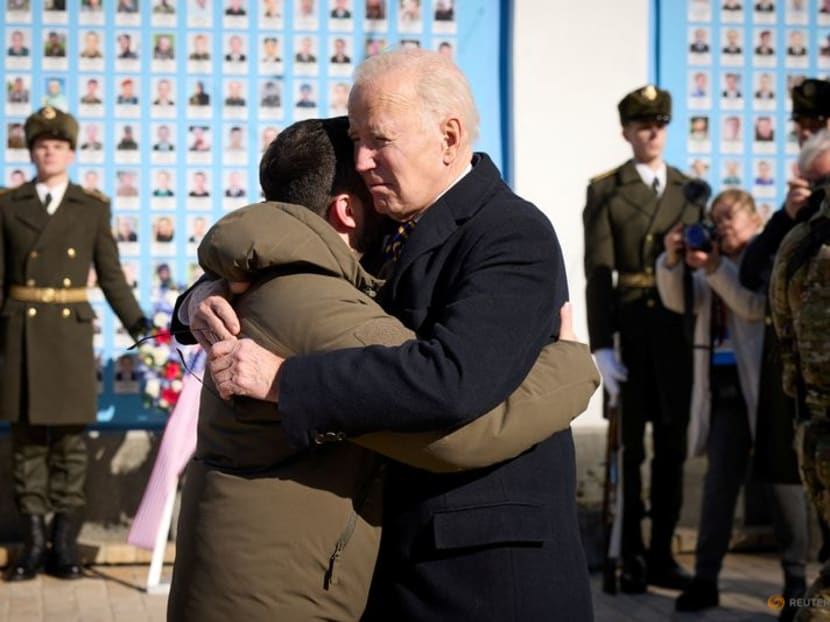 US President Joe Biden embraces Ukraine's President Volodymyr Zelenskiy as they visit the Wall of Remembrance to pay tribute to killed Ukrainian soldiers, amid Russia's attack on Ukraine, in Kyiv, Ukraine February 20, 2023. 