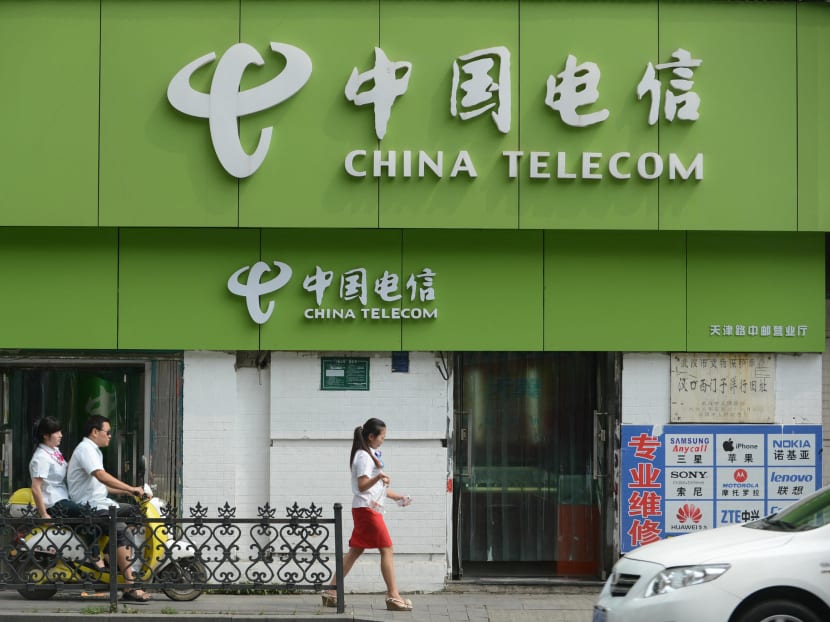 People walk past a China Telecom store in Wuhan, China, on Aug 21, 2013. People walk past a China Telecom store in Wuhan, China, on Aug 21, 2013.