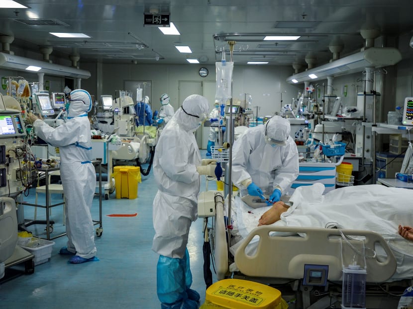 Medical staff treat patients infected by the Covid-19 coronavirus at a hospital in Wuhan in China's central Hubei province.