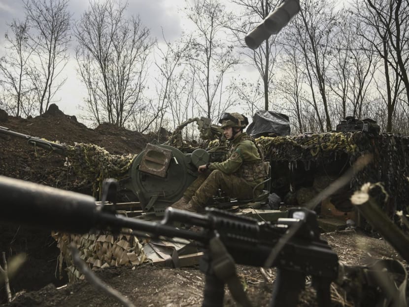 An Ukrainian serviceman sits on an anti-air gun near Bakhmut, on March 24, 2023.