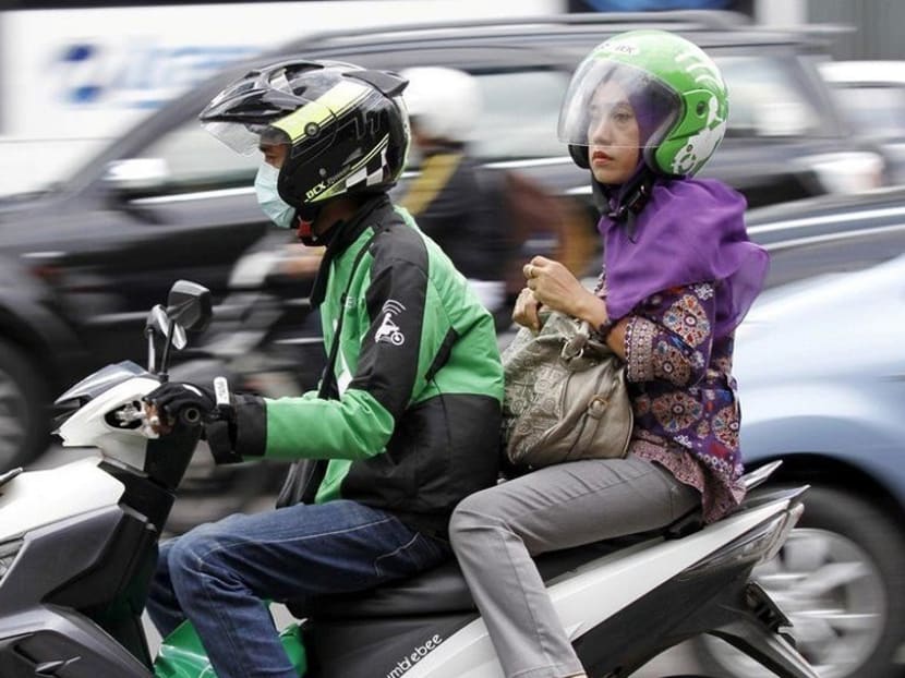 A woman uses the Go-Jek service in Jakarta.