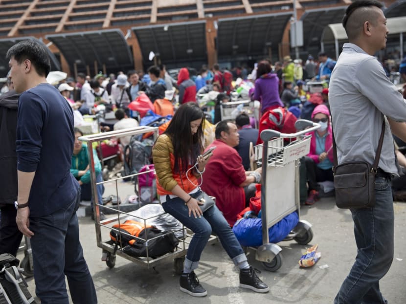 People wait to go inside the Kathmandu international airport, in Kathmandu, Nepal. Photo: AP