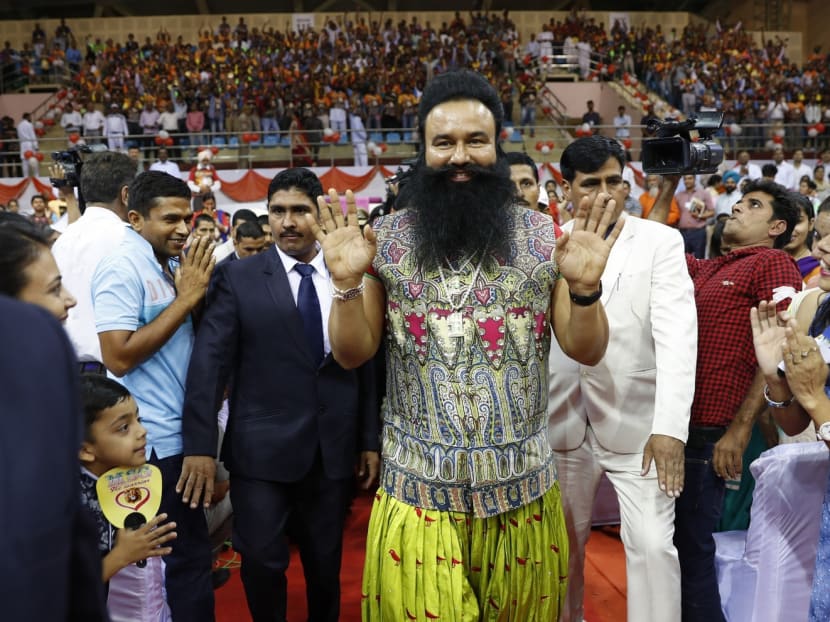 The Indian spiritual guru who calls himself Baba Gurmeet Ram Rahim Singh Insan (centre) greeting followers in New Delhi. His conviction on two counts of raping young girls sparked violence across India and questions over how he was seemingly able to live above the law. Photo: AP