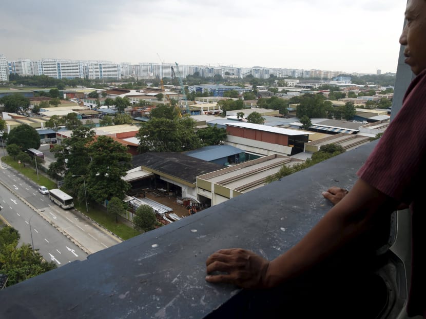 A man looks at a cluster of factories at an industrial park in Singapore in this September 16, 2014 file photo. Photo: Reuters