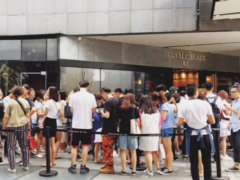 Customers waiting in line at a bubble tea shop in China. Photo: Caixin