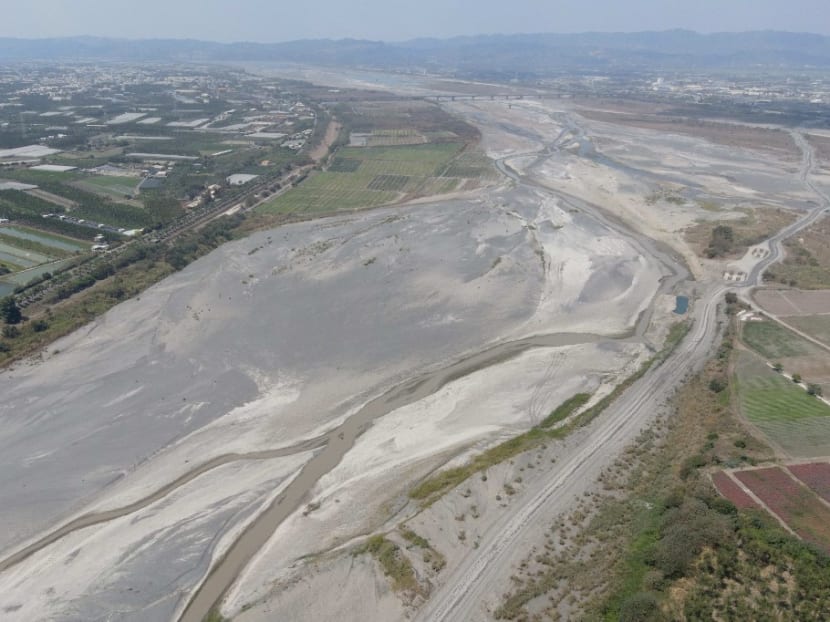 This picture taken on March 16, 2021 shows an aerial view of the dry Ai Liao River bed in Taiwan's Pingtung county. More than one million households and businesses in Taiwan's heavily industrialised central regions were put on water rationing on April 6, 2021, as the island battles its worst drought in 56 years. This picture taken on March 16, 2021 shows an aerial view of the dry Ai Liao River bed in Taiwan's Pingtung county. More than one million households and businesses in Taiwan's heavily industrialised central regions were put on water rationing on April 6, 2021, as the island battles its worst drought in 56 years.