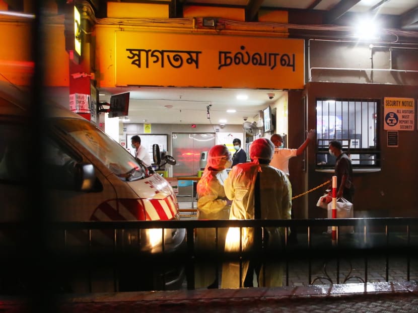 The police and medical personnel were seen at the entrance of Westlite Toh Guan dormitory at Block 28, Toh Guan Road East, as workers return for the day on Sunday, April 5, 2020.