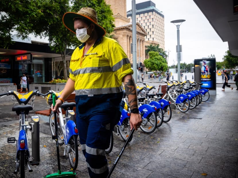 A Brisbane City Council worker wears a mask along the Queen Street Mall in Brisbane on Friday, Jan 8, 2021, as Australia's third-largest city headed into lockdown and borders set to tighten nationwide after a cleaner at a quarantine hotel contracted the UK coronavirus strain that appears to be more infectious.