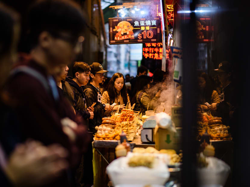 Customers queueing to buy snacks being sold by food vendors along a street in Hong Kong on Jan 31, 2017. Sodium content levels in popular Hong Kong dishes have remained the same, according to the city’s consumer watchdog. Photo: AFP