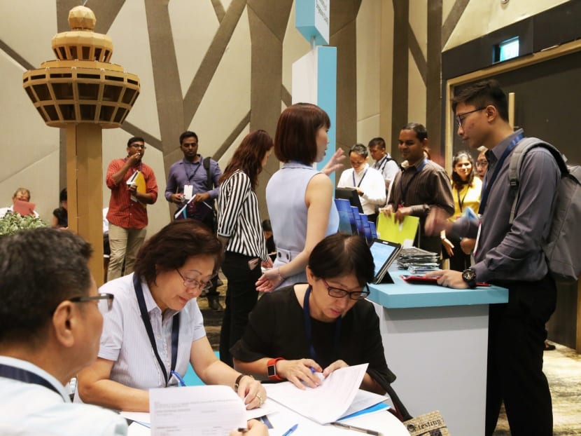 Job seekers making queries at the Adapt And Grow job fair at Crowne Plaza Changi Airport on Feb 8, 2017. TODAY file photo