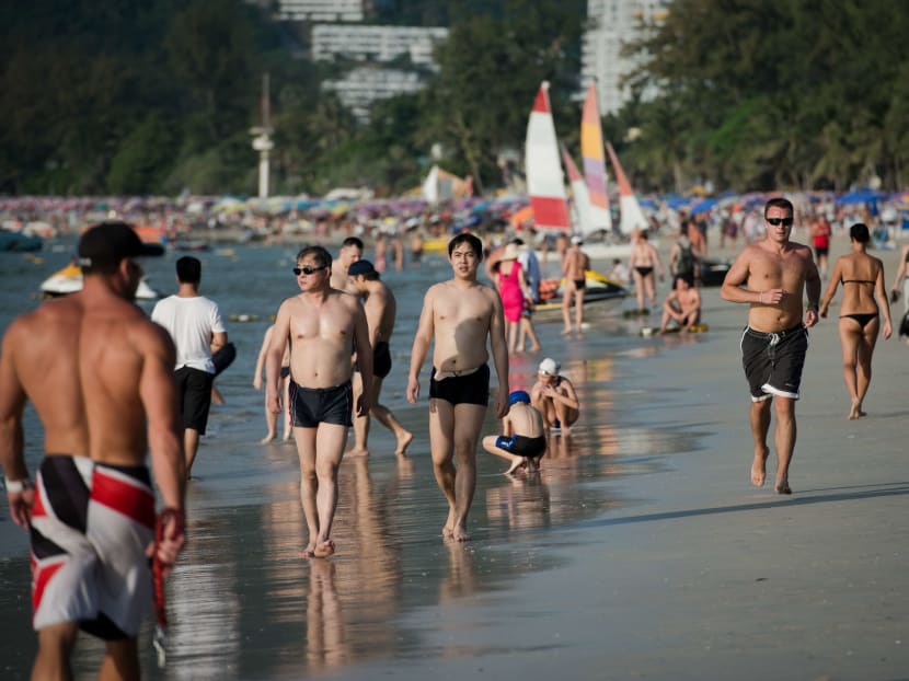 Tourists stroll on Patong Beach in Phuket, southern Thailand. Photo: AFP