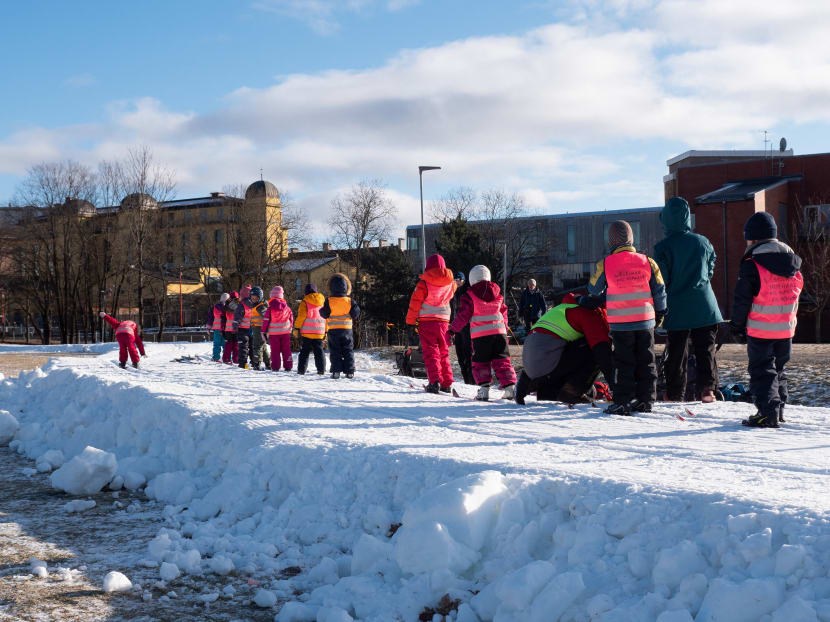 Picture taken on February 10, 2021 shows children on excursions with their daycare groups, cross-country skiing on trails made of artificial snow in Oslo, Norway.