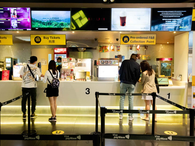 Moviegoers practice safe distancing while purchasing tickets at Golden Village cinema at Tampines Mall shopping centre on Monday, July 13, 2020.