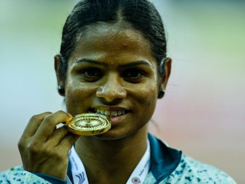 Dutee Chand of Odisha poses with her winning medal after victory in the 100 metre race during 20th Federation Cup National Senior Athletics Championship in New Delhi on April 28, 2016. 
CHANDAN KHANNA / AFP