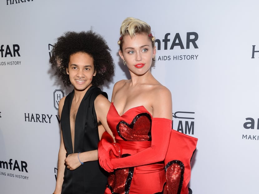 Honouree Miley Cyrus, right, arrives with friend Tyler Ford at the 6th Annual amfAR New York Inspiration Gala at Spring Studios in New York on June 16, 2015. Photo: AP