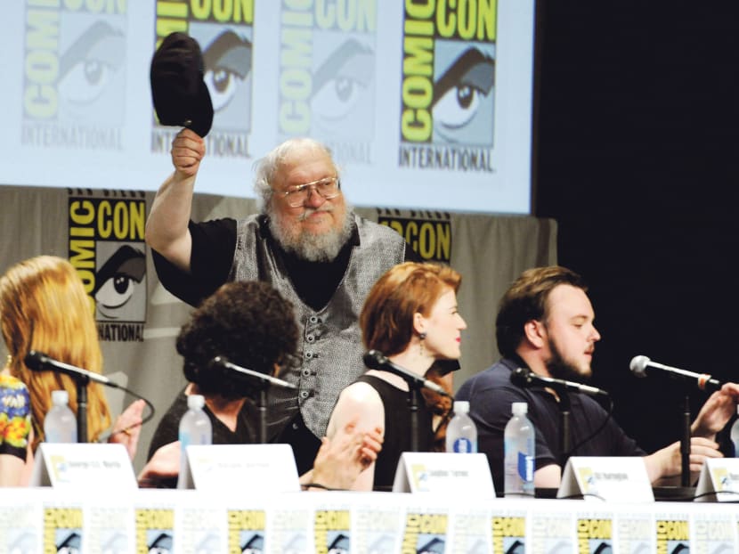 George R R Martin attends the Game of Thrones panel on Day 2 of Comic-Con International, July 25, 2014, in San Diego. Looking on from left are Sophie Turner, Kit Harington, Rose Leslie and John Bradley. Photo: AP