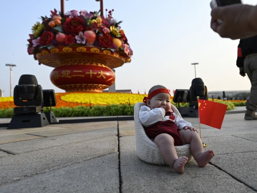 A woman takes a photo of a baby in front of an installation celebrating the upcoming National Day and the 20th Communist Party Congress at Tiananmen Square in Beijing on Sept 29, 2022.
A woman takes a photo of a baby in front of an installation celebrating the upcoming National Day and the 20th Communist Party Congress at Tiananmen Square in Beijing on Sept 29, 2022.