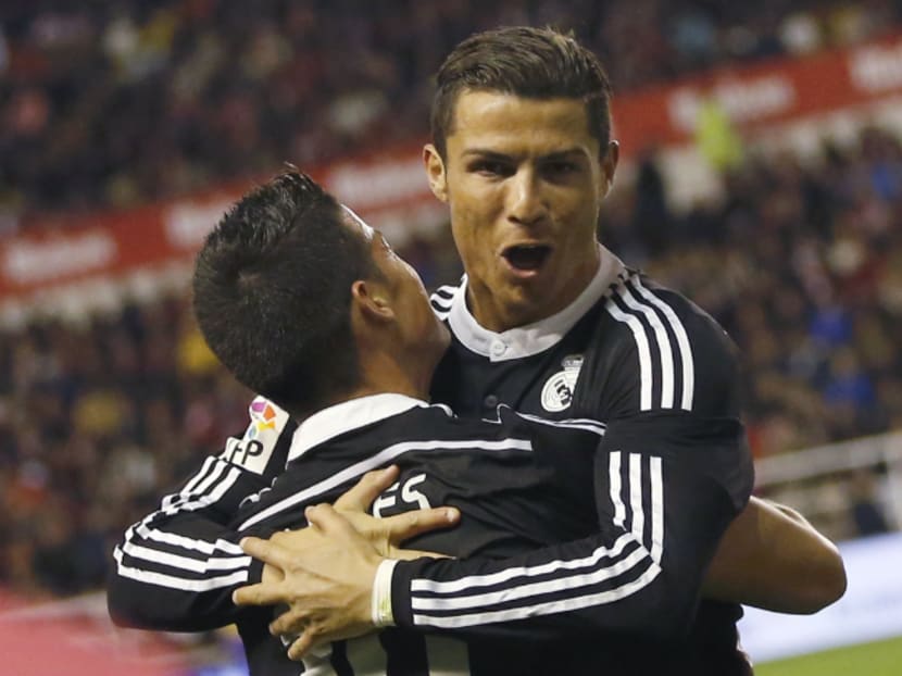 Real Madrid's James Rodriguez is congratulated by his team mate Cristiano Ronaldo (R) after scoring a goal against Rayo Vallecano during their Spanish first division soccer match at Vallecas stadium in Madrid April 8, 2015. Photo:Reuters